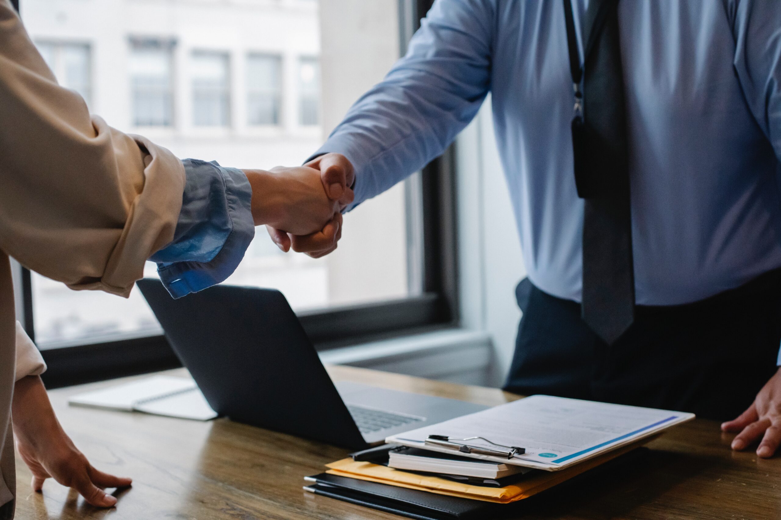 Employee handshake, in office